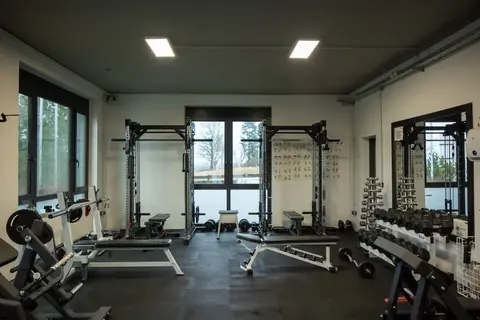 Freihantelbereich mit Kabelzug, Bänken und Hanteln im Revex beFIT